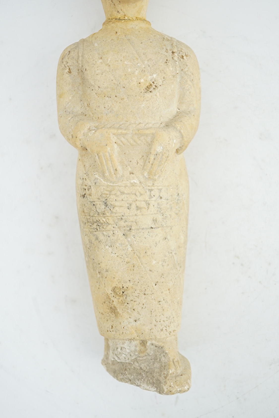 An unusual limestone votive figure, with cuneiform inscription, possibly Mesopotamian